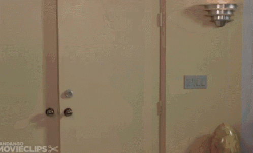 a man in a suit and tie is standing in a doorway with the words andango movieclips on the bottom