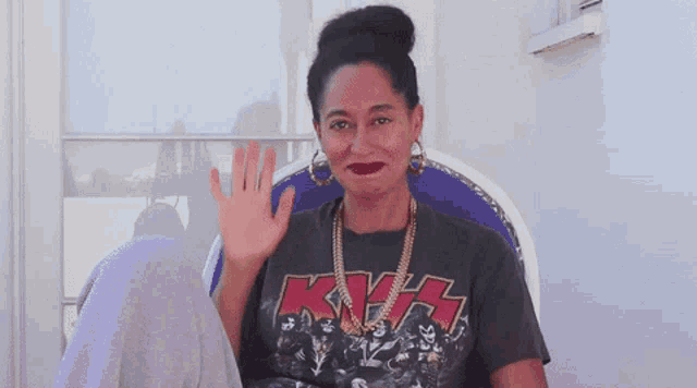 a woman wearing a t-shirt that says kiss on it