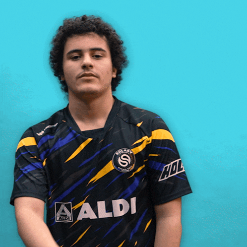 a man wearing a black shirt with aldi on the front