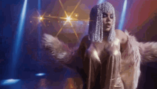 a woman in a wig and fur coat is dancing in a dark room .