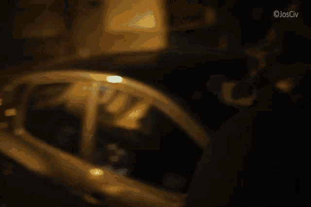 a blurred image of a person standing next to a car with the watermark ojosciv at the bottom