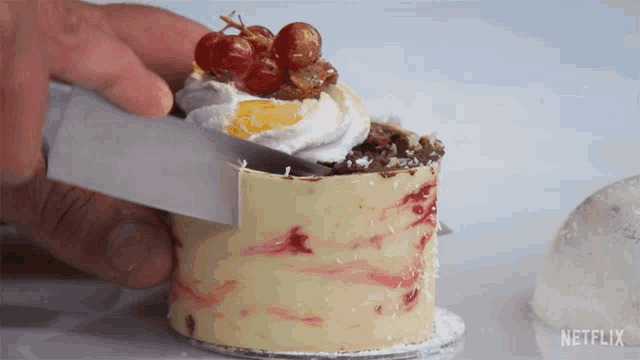 a person is cutting a cake with netflix written on the bottom
