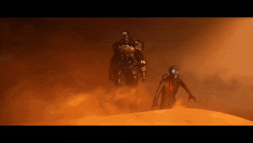 a man in a gas mask is walking through a desert .