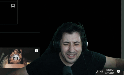 a man wearing headphones and a black shirt with the number 73 on the bottom
