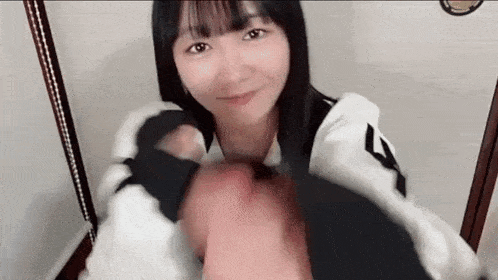 a close up of a woman holding a man 's hand in her mouth .