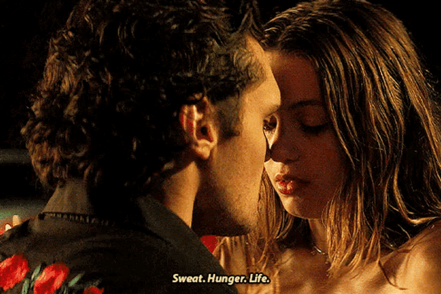 a man kissing a woman with sweat hunger life written on the bottom