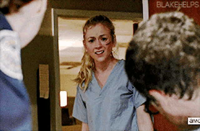 a woman in scrubs stands in front of a man with blake helps written on the bottom