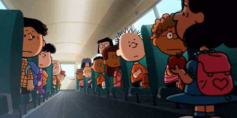 a group of peanuts characters sitting on a school bus
