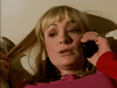 a woman with blonde hair is talking on a phone