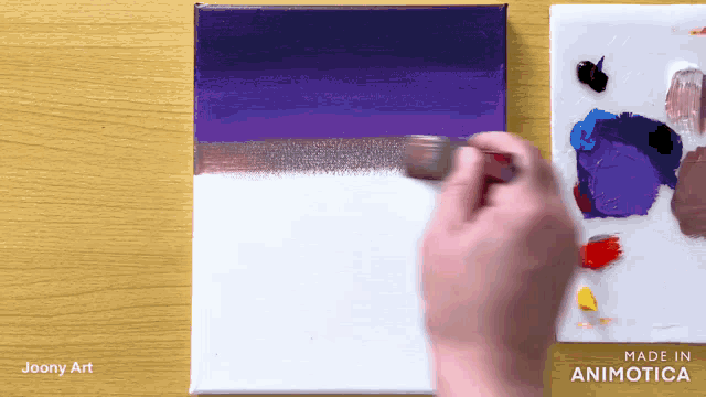 a person is painting on a canvas with a palette in the background