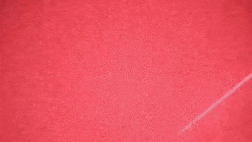 a red light is shining on a dark surface