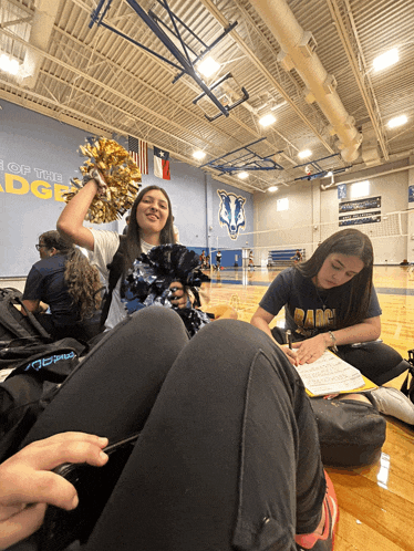 two girls are sitting on the floor in front of a wall that says ' ridge ' on it