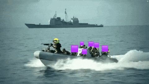 a group of people in a boat in the ocean with purple squares around their faces