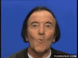 a man with a surprised look on his face is on a blue background with the website yourrepeat.com below him
