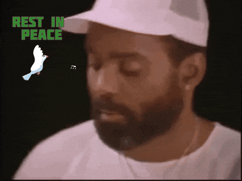 a man with a beard is wearing a white hat with the words rest in peace behind him