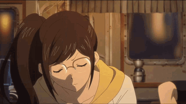 a girl with glasses and a ponytail is looking down with her eyes closed