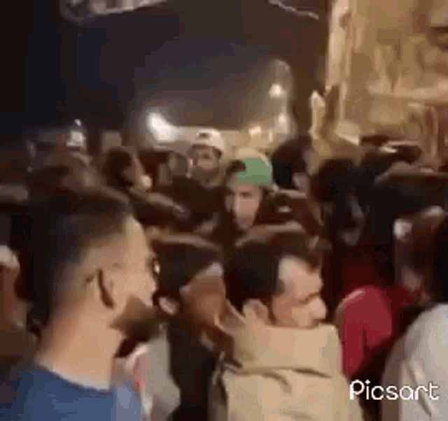 a crowd of people are standing in a line at a party .