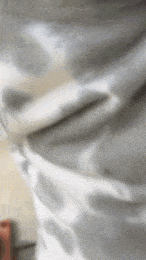 a close up of a gray and white blanket with a polka dot pattern