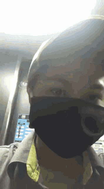 a person wearing a mask with a phone in the background that says ' nfc ' on it
