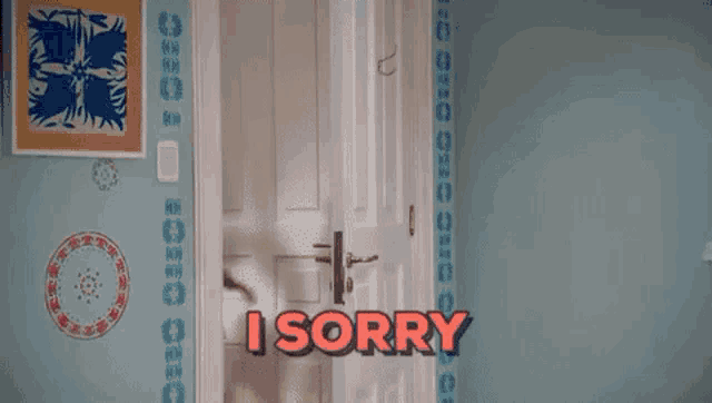 a woman in a pink sweater and blue skirt is standing in a doorway and saying `` i sorry '' .