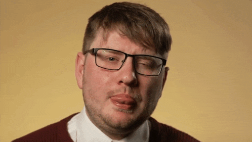 a man wearing glasses making a funny face