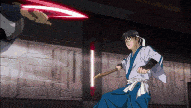 a man in a kimono is holding a wooden stick in his hand