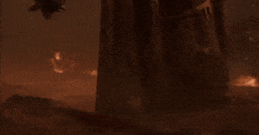 a person with a skull on their head is holding a large axe in a dark room