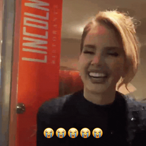 a woman is smiling in front of a lincoln restaurant