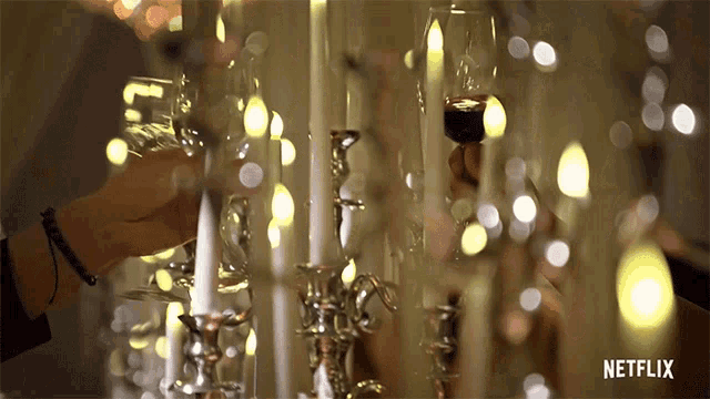 a netflix advertisement shows a person holding a glass of wine
