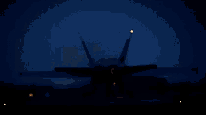 a fighter jet is taking off from a runway at night .