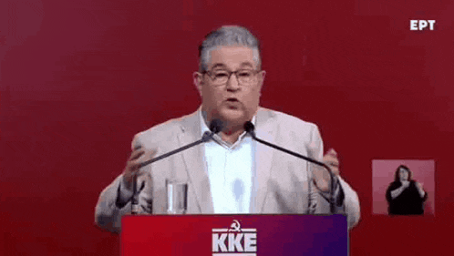 a man in a suit is giving a speech at a podium with a sign language interpreter behind him .