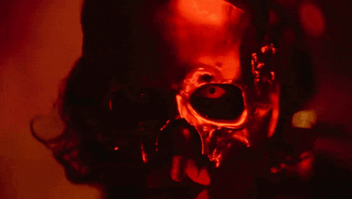 a close up of a person 's face in a red light