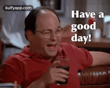 a man is laughing while holding a glass of soda and saying `` have a good day '' .