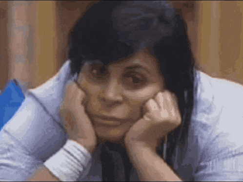 a woman with her head resting on her hands .