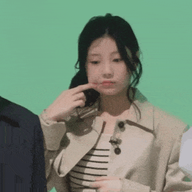 a woman with a ring on her finger is making a face