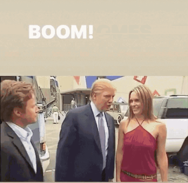 a man in a suit and tie is talking to a woman in a red dress with the word boom above them