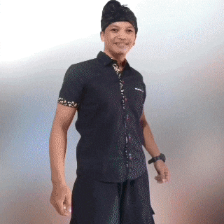 a man wearing a black shirt and a black hat stands in front of a white background