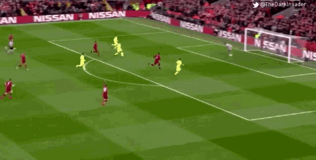 a soccer game is being played on a field with nissan advertisements on the sidelines