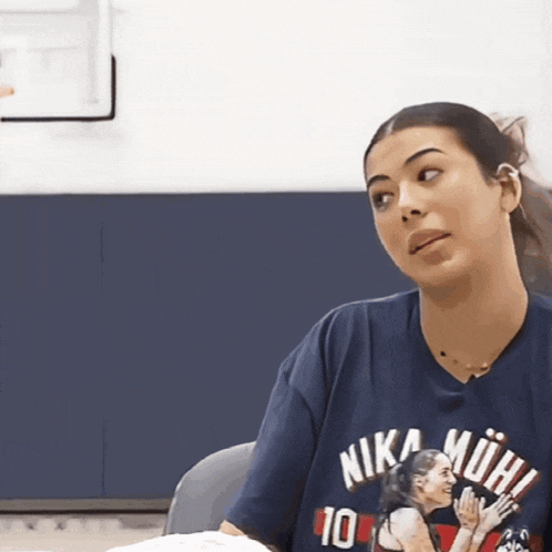 a woman wearing a shirt that says nika mohi