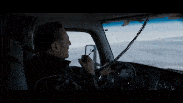 a man sits in the driver 's seat of a truck that says kenworth