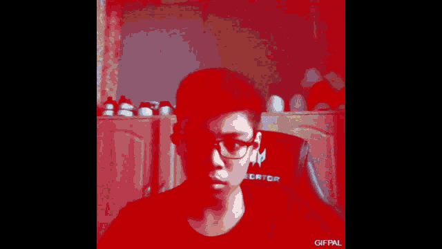 a blurry picture of a boy with glasses and the words gifpal on the bottom right