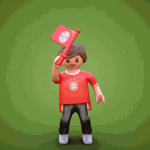 a playmobil figure is wearing a red shirt that says fc bayern