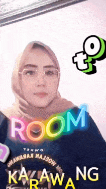 a woman wearing glasses and a hijab with room karawang written on her shirt