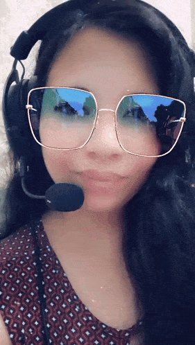 a woman wearing glasses and headphones with a microphone on her head