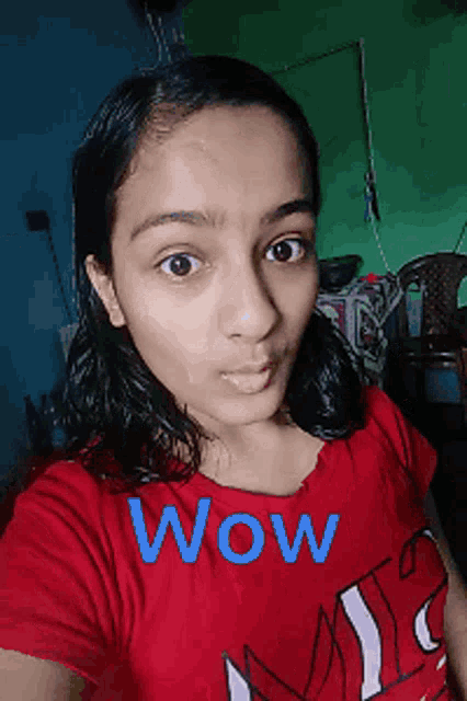 a girl wearing a red shirt with wow written on it