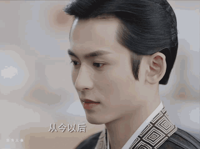 a close up of a man 's face with chinese writing on the bottom left