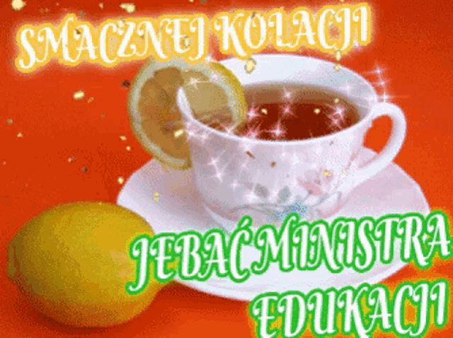 a cup of tea with a slice of lemon next to it