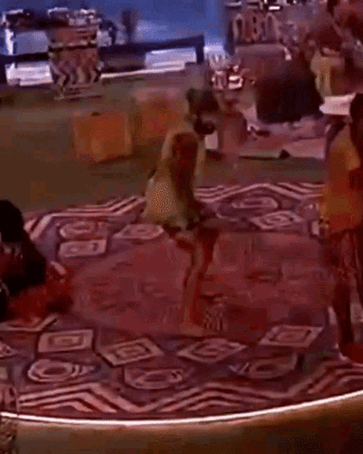 a group of people are dancing on a rug with a sign that says nba on it