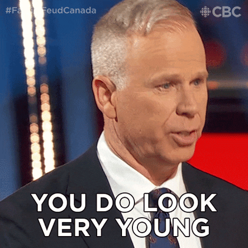 a man in a suit and tie is saying " you do look very young "