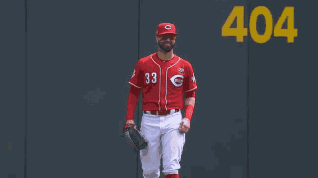 a baseball player wearing a red uniform with the number 33 on it